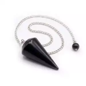 Matte black shungite pendulum on a silver chain, photographed on a light surface to show its smooth faceted form