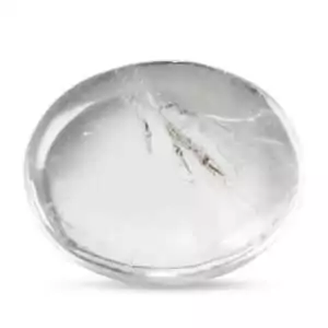 Clear quartz worry stone with smooth thumb groove showing transparent crystal clarity, used as a programmable master healer and intention-setting tool.