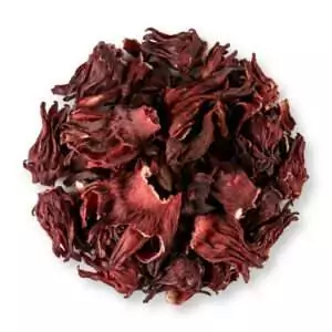 Dried hibiscus Hibiscus sabdariffa whole flowers in a pile showing the deep red dried petal material for love magic ritual