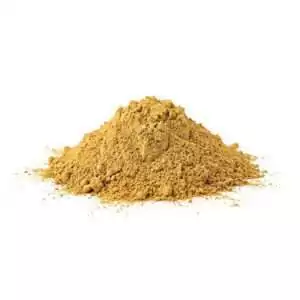 Yellow sandalwood powder Santalum finely ground in a circular pile, showing the pale cream-tan color of true sandalwood heartwood powder