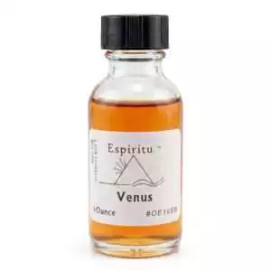 Clear glass bottle of Espiritu Venus ritual oil 1oz labeled with golden liquid — love and beauty condition oil.