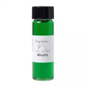Small glass vial with black cap filled with bright green liquid labeled Espiritu Wealth, a ritual money-drawing fragrance oil.