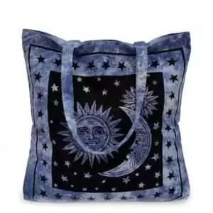 Sun and Moon Tote Bag — blue canvas carry-all with celestial illustrated sun and moon surrounded by stars for witchy daily use and spiritual supply toting.