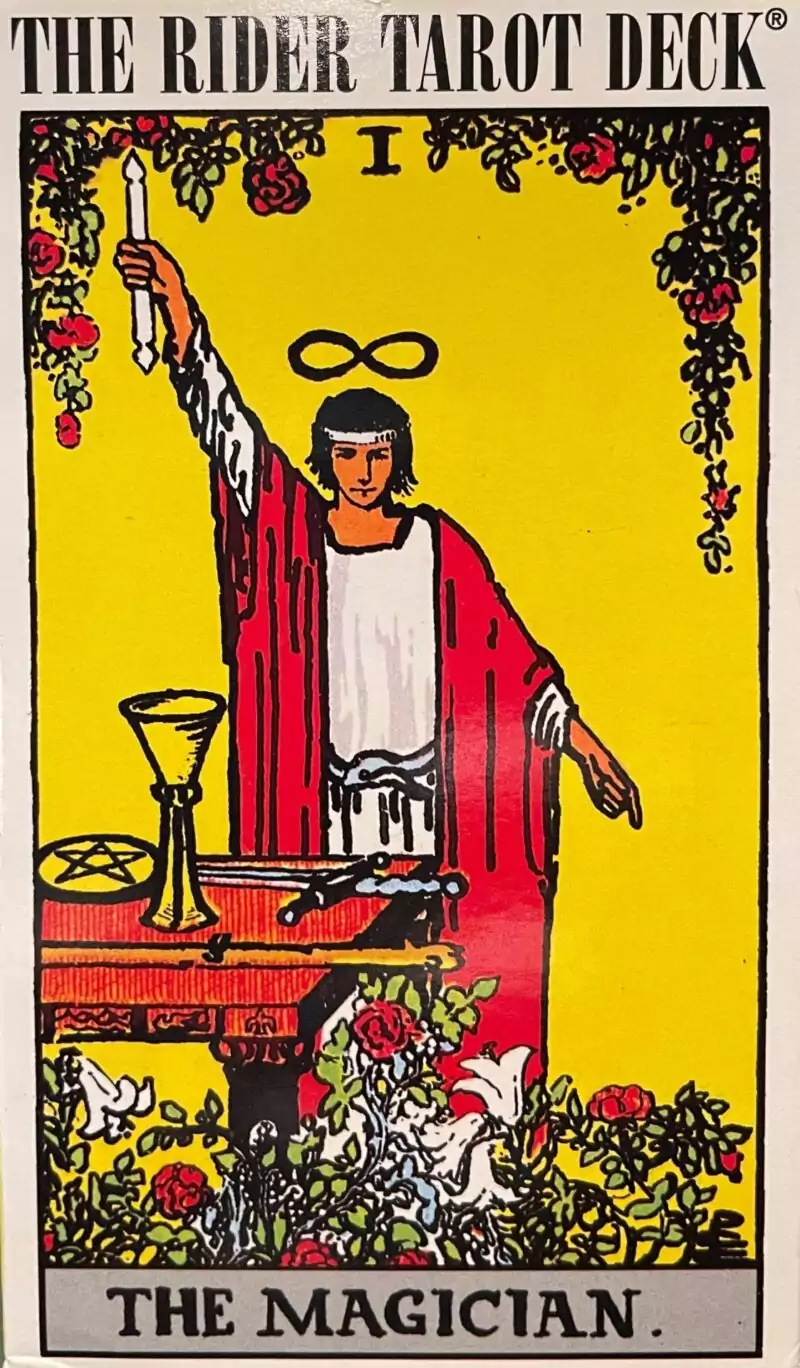 RiderWaite Rider-Waite Tarot Magician card showing a robed figure with one arm raised holding a wand above an altar bearing the four suit symbols.