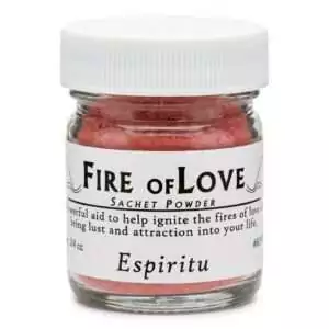 Small clear glass jar of red Fire of Love sachet powder with a labeled lid reading the name and indicating attraction and passion formula.