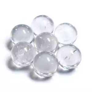 One pound of 15-25mm polished clear quartz crystal marbles mini spheres in pile for crystal grids and altar decor