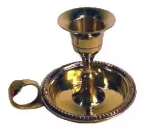 Brass chamberstick taper candle holder — circular saucer base with finger loop handle in polished brass for holding a single taper candle.
