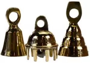 Set of twelve small brass ritual bells arranged on a surface showing their round domed shape and warm brass finish