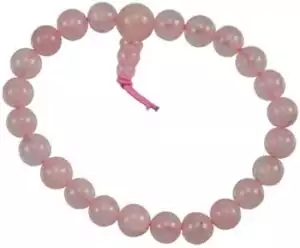 Rose quartz power bracelet of small round pink stone beads strung on a pink cord with a tied closure, displayed on white background