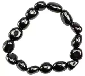 Hematite man-made gemstone bracelet of smooth polished black beads in irregular arrangement on elastic cord, circular display
