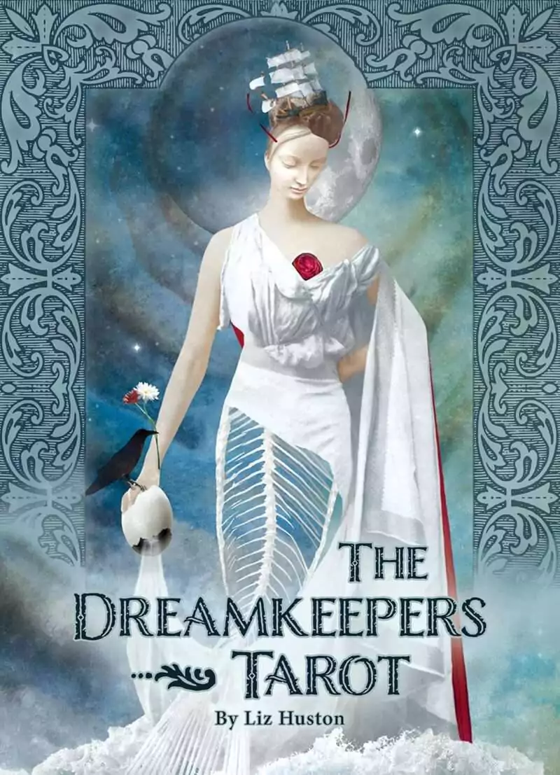 DDRETAR_Z_1 Dreamkeepers Tarot box cover showing a woman in a flowing white gown holding a swan and rose against a deep blue dreamscape background.