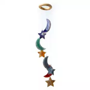 A colorful hanging mobile featuring crescent moons and stars in various shades. The design includes a circular top from which the shapes are suspended.