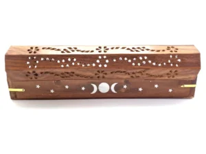 Decorative wooden incense box open to reveal interior, with intricate floral and moon cut-out patterns on the lid and natural wood finish.