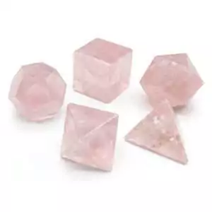 Five rose quartz platonic solids crystal set showing tetrahedron cube octahedron dodecahedron and icosahedron geometric shapes in pink stone.