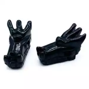 Set of 2 black obsidian volcanic glass dragon head carvings in glossy black for psychic protection, truth work, and dramatic guardian altar display.