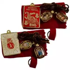 Pewter Secrets of Money talisman amulet with cord alongside a small red instruction booklet — wealth and prosperity amulet set.