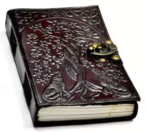 Wolf Tree of Life leather grimoire journal with intricate floral and animal embossed design on cover — 5x7 inch leather journal with metal latch clasp for grimoire and ritual records.
