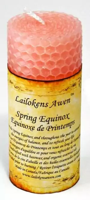 Pink honeycomb-textured beeswax pillar candle with a Spring Equinox label in English and French, handcrafted in Canada by Lailokens Awen for Ostara altar use.