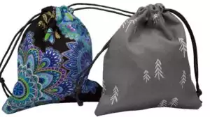 A lined drawstring nature-themed tarot bag made in the USA, showing botanical print fabric in a small pouch with gathered top closure for deck storage.