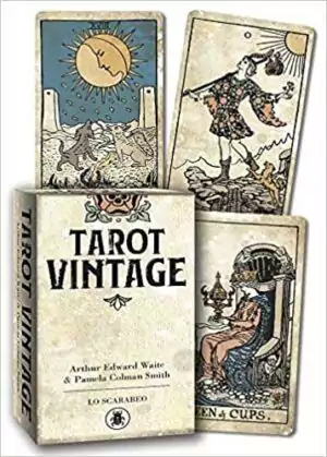 Tarot Vintage deck by Lo Scarabeo showing aged sepia-toned Sun card and other classic RWS cards alongside the box — a 2021 linen-finish antique-style Waite-Smith edition.
