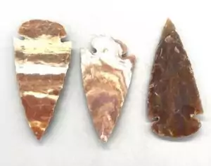 2-inch carved jasper arrowhead showing natural stone colors and traditional pointed arrowhead shape — protection talisman charm.