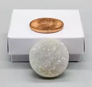 A one-inch round amethyst druzy cabochon with flat back and sparkling deep-purple crystal point surface, circular shape perfect for jewelry settings.