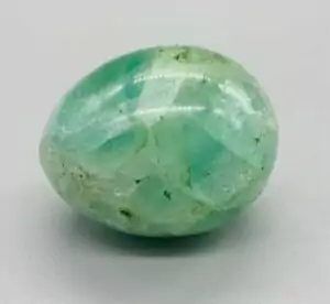 Polished fluorite crystal egg approximately 1.7 inches tall, displaying rainbow banding of purple, green, and teal mineral zones on a white background.