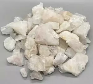 Approximately three pounds of rough morganite pink beryl crystal specimens in a bulk flat, showing soft peachy-pink coloration on raw unpolished mineral pieces.