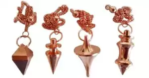 Copper plated brass conical pendulum on a chain, showing warm metallic sheen and classic traditional dowsing tool shape