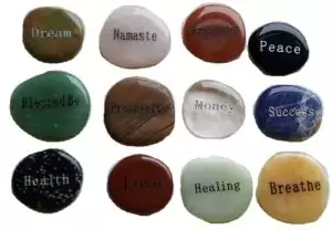 Smooth oval worry stone engraved with an inspirational word for affirmation practice mindfulness and daily intention setting