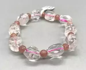 Quartz and strawberry quartz nugget bracelet showing clear and pink irregular stone beads on stretch cord — heart chakra stacking bracelet.