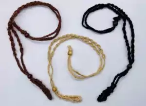 Crystal net necklace cords in assorted colors — brown, beige, and braided cord necklace holders with small net cages for carrying tumbled stones as pendants.
