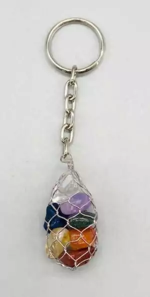 Crystal gemstone keychain with colorful mixed tumbled stones in a mesh netting bag and silver key ring — a portable multi-stone crystal energy carry for everyday use.