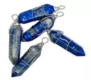 Five blue crystal pendants wrapped in silver wire, showcasing a variety of shades and textures. The crystals are arranged in a slightly overlapping manner.