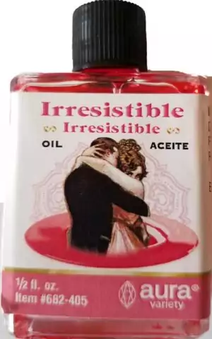 Small 4-dram bottle of Irresistible ritual oil with bilingual label featuring an illustration of an embracing couple, from Aura Variety botanica line.