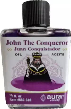 Small 4-dram John the Conqueror condition oil bottle with a crowned figure holding a scepter — Aura Variety label in English and Spanish.