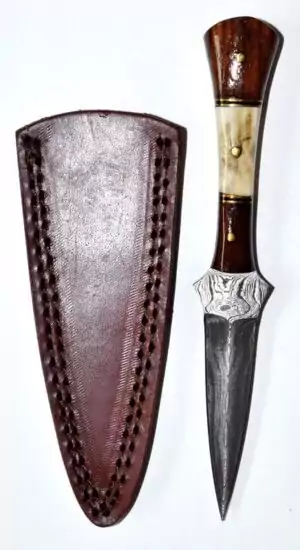A 7-inch baby stag Damascus athame showing the patterned Damascus steel blade and natural stag horn handle, a handcrafted ritual dagger for ceremonial magic.