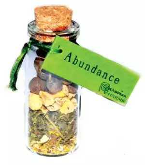 Small corked glass abundance pocket spellbottle with Jupiter herbs and crystals for prosperity wealth and manifestation ritual charm