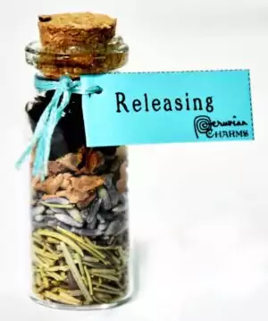 Releasing pocket spell bottle — miniature ritual intention jar filled with herbs and crystals for letting go and emotional release rituals.
