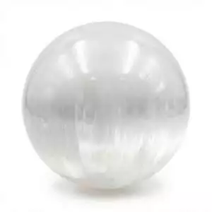 Selenite gazing ball — smooth translucent white sphere with soft internal glow, used for meditation focus, altar energy cleansing, and creative clarity work.