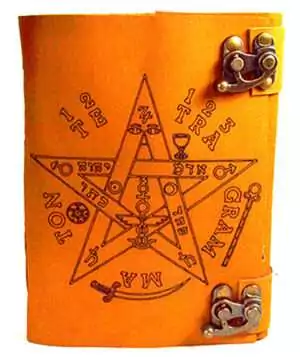 Orange-toned aged leather-look journal with embossed pentagram and Tetragrammaton Hebrew lettering surrounded by mystical symbols, secured with a metal clasp.