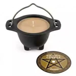 Small black cauldron-shaped ritual candle with beige wax interior accompanied by a round pentagram design label, patchouli scented for Wiccan altar use