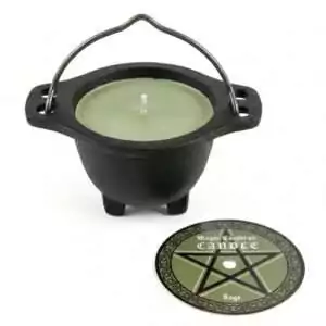 Small black cast iron cauldron containing a green sage-scented wax candle for altar cleansing and ritual decoration