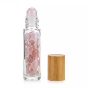 Rose quartz crystal roller bottle 10ml with pink gemstone roller ball — empty ritual vessel for self-love oil blends and heart chakra practice.