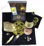 Mystical Rider-Waite gold foil tarot set displayed on black cloth with cards, crystals, and ritual tools with celestial and alchemical symbols.