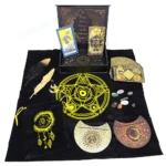 Collection of RWS gold foil tarot cards, crystals, feathers, and decorative circular pieces arranged on black cloth with a yellow pentagram design.