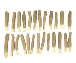 Collection of brown palo santo sticks dipped in white sage, arranged in rows for ritual cleansing and smudging use.