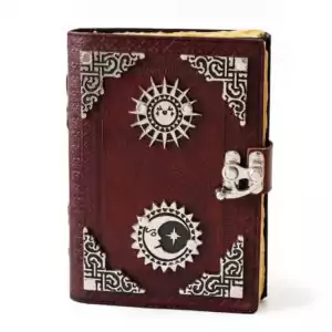Sun and Moon embossed leather journal with aged paper and latch closure showing celestial grimoire with sun and moon symbols on leather cover
