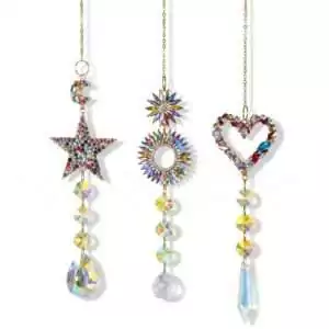 Three crystal prism sun catchers in star, sunburst, and heart shapes with colorful beads hanging from strings for window rainbow light display.