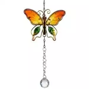 Colorful stained glass butterfly ornament with green leaf accents in red, orange, and yellow hues, hanging from a chain with a crystal prism at the bottom.